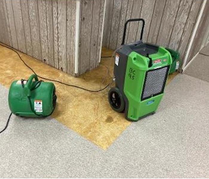 Carpet and wet material removed and SERVPRO drying machines installed.