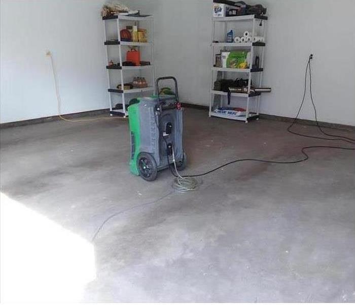 Garage floor cleaned after storm damage.